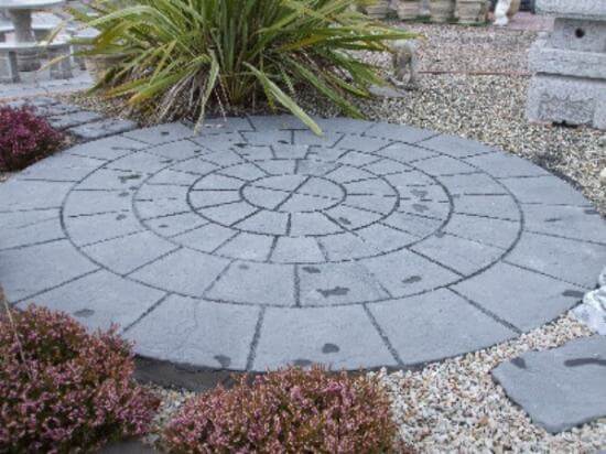 Circular granite plaza with cobblestone around