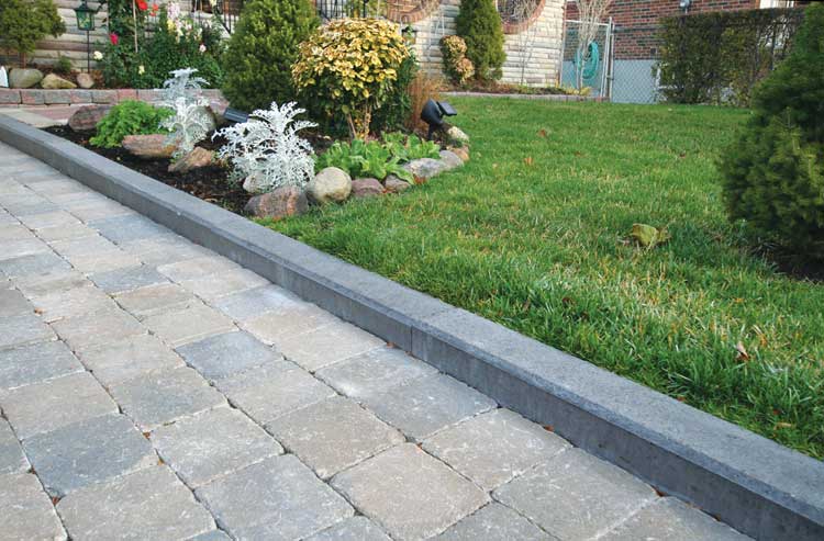 Square sandstone patio with granite pathway and curbstones