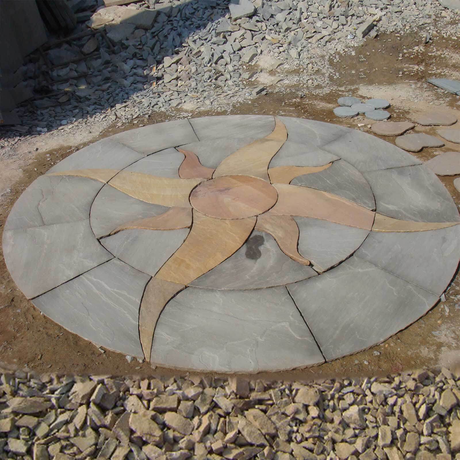 Circular sandstone paving with sun wheel design