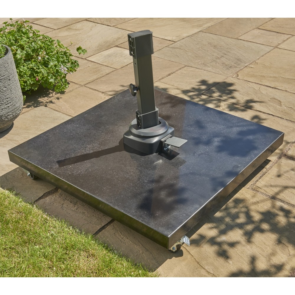 Black granite parasol base on rusty stone patio